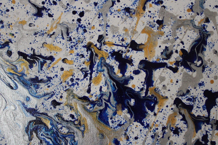 Abstract pattern with blue, yellow, and black splashes on a white background