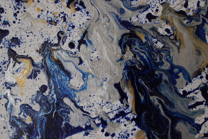 Abstract art with blue, black, and gold colors on a textured surface